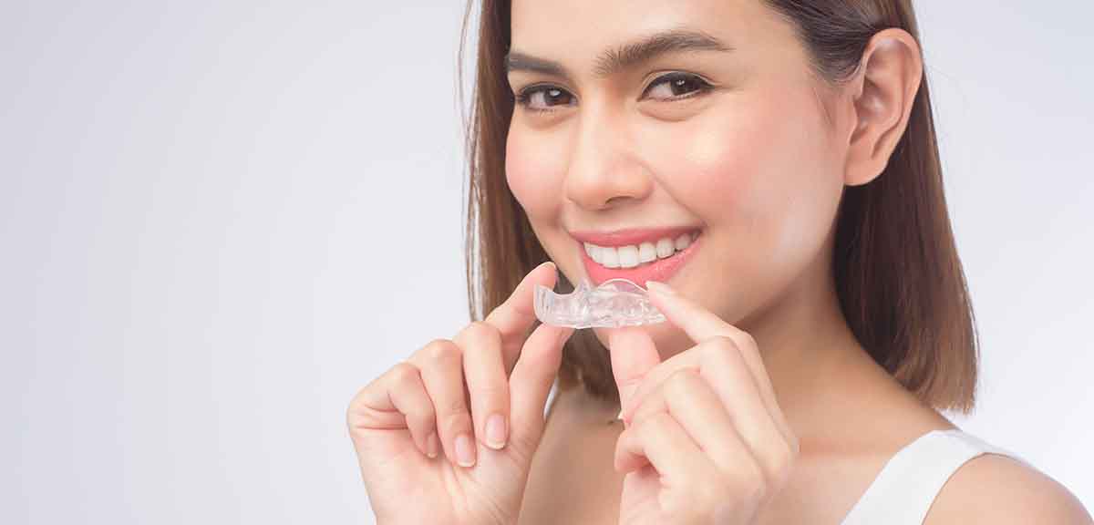 adult with clear aligners invisalign